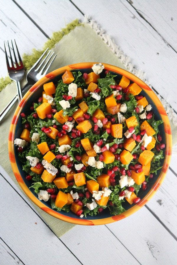 Kale Salad with Butternut Squash in a big bowl set on green napkin with forks