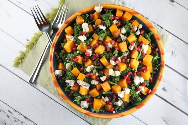 Kale Salad with Butternut Squash in a large bowl set on green napkin with forks