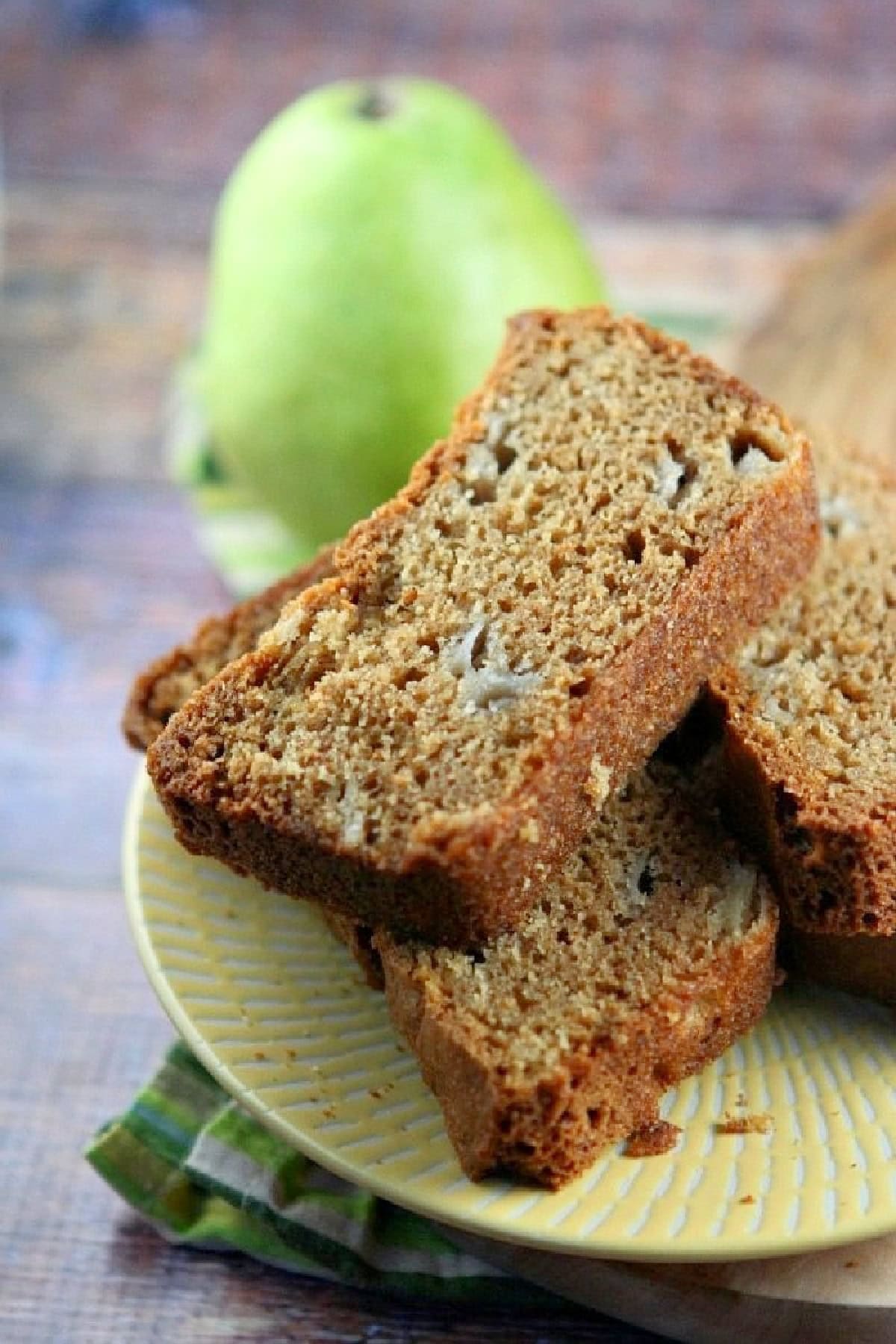 slices of pear bread with a fresh green pear