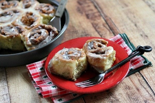 No Yeast Eggnog Cinnamon Rolls on a red plate with a fork