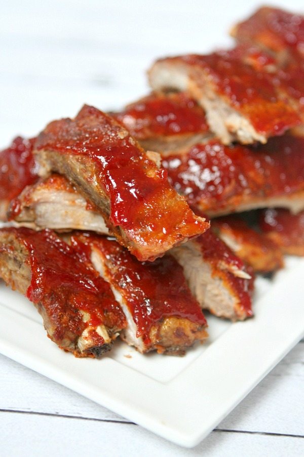 Slow Cooker Sriracha- Cranberry Baby Back Ribs on white platter