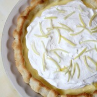 lemon sour cream pie garnished with lemon rind