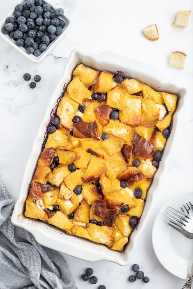 overnight blueberry french toast in a white casserole dish