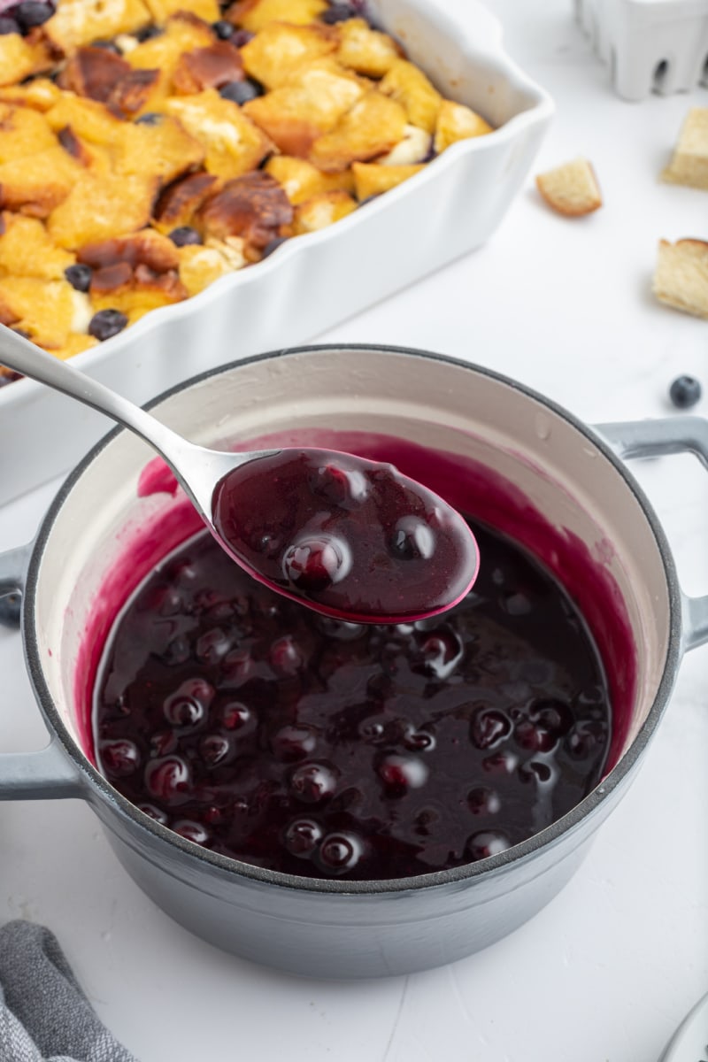 blueberry sauce in a bowl with a spoon