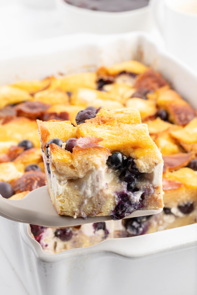 slice of overnight blueberry french toast on spatula