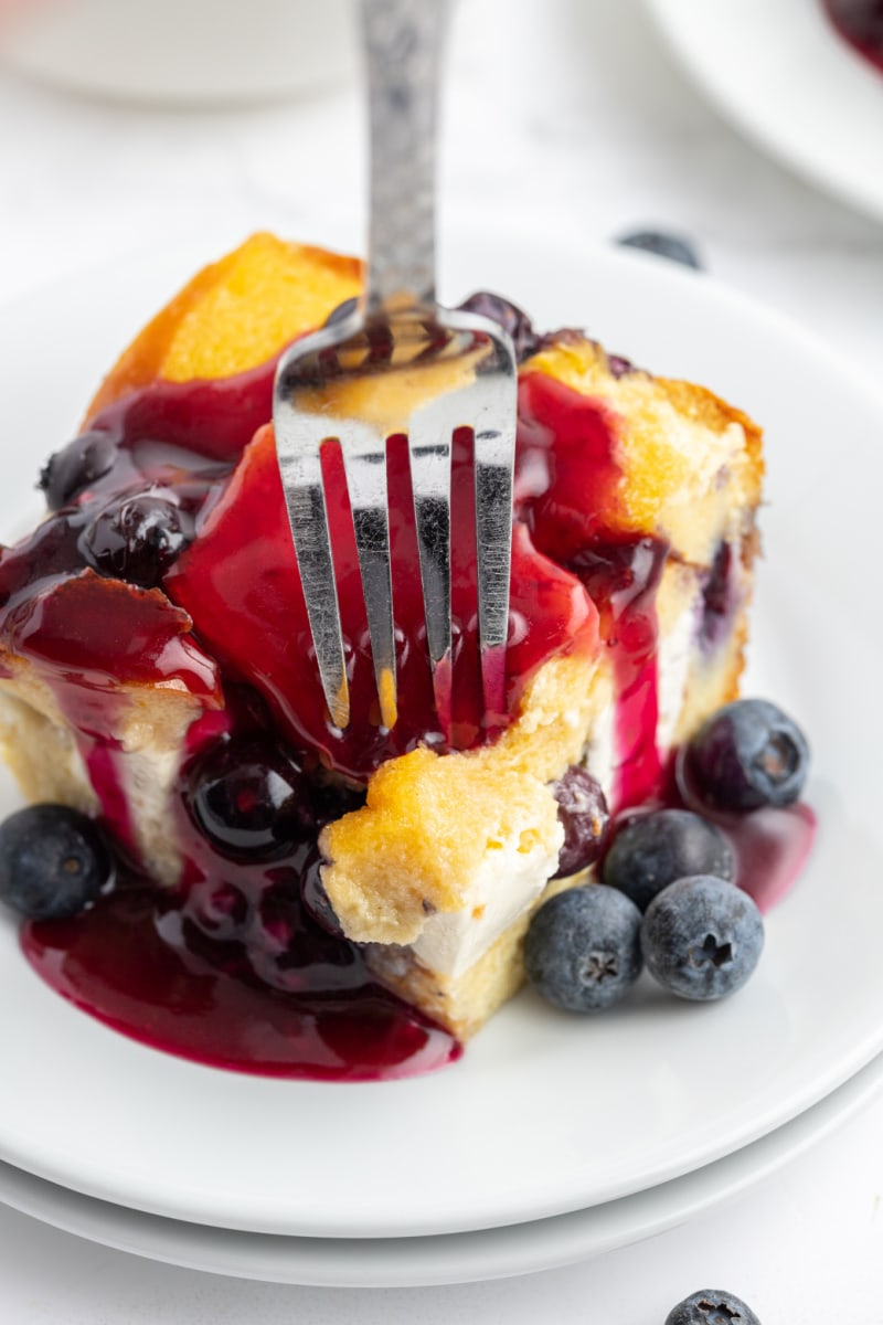 slice of blueberry french toast on plate with fork sticking out of it