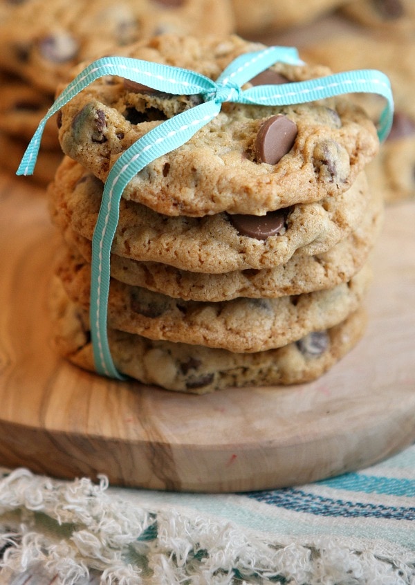 Oatmeal Chocolate Chip Cookies stacked on board with ribbon