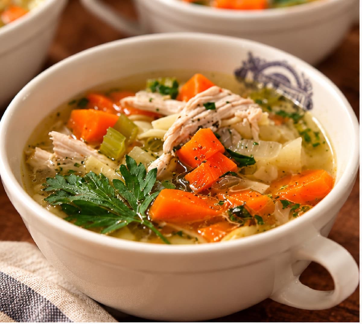 Save this Classic Chicken Soup recipe for chilly days! A whole chicken is slowly simmered in flavorful broth with carrots, celery, onion, parsnip and fresh herbs. Keep it simple or add noodles to turn it into homemade chicken noodle soup. classic chicken soup in bowl