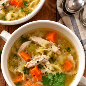 overhead shot classic chicken soup in bowls