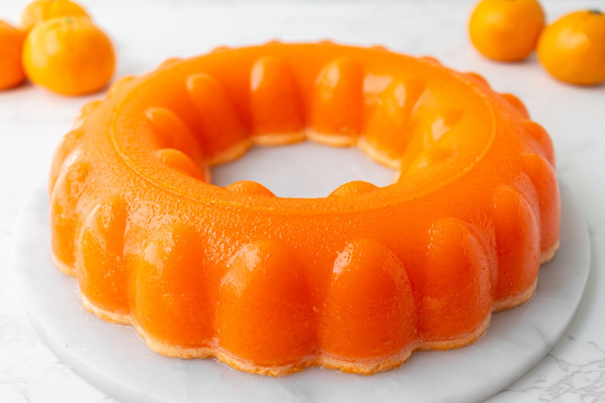 Cool, creamy, and perfectly nostalgic — this Orange Sherbet Jello Salad is made with orange Jell-O, sherbet, and mandarin oranges. The perfect citrusy dessert for holidays, brunches, and family gatherings! molded orange sherbet jello salad ring