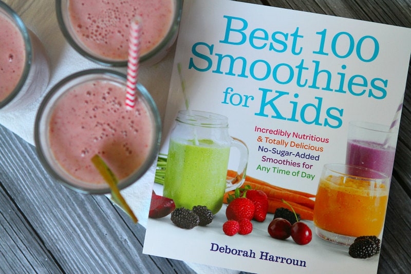 Best 100 Smoothies for Kids cookbook cover with overhead shot of three strawberry kiwi smoothies with straws