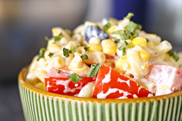 close up shot of summer macaroni salad in a green bowl