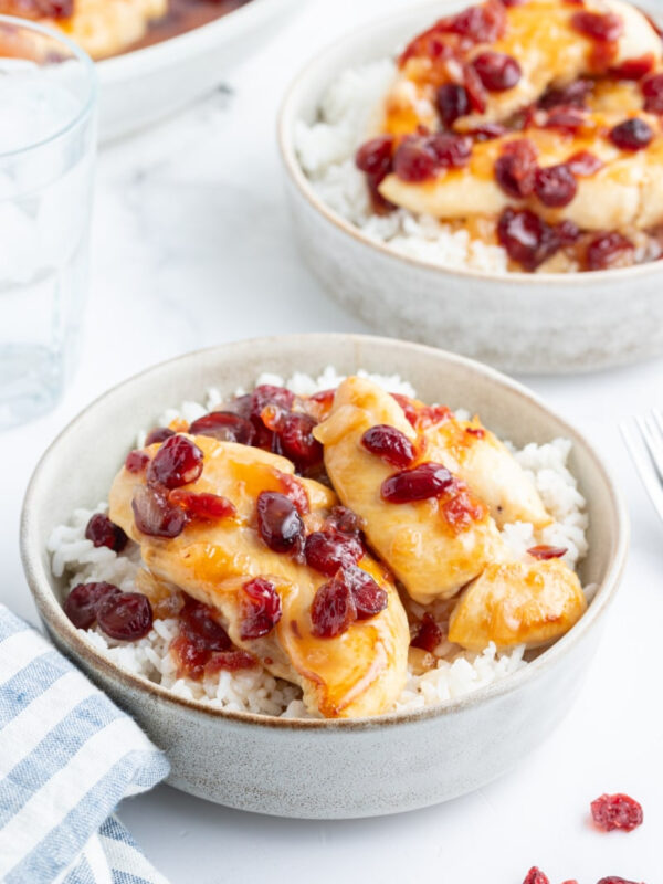 apricot cranberry chicken in bowls over rice