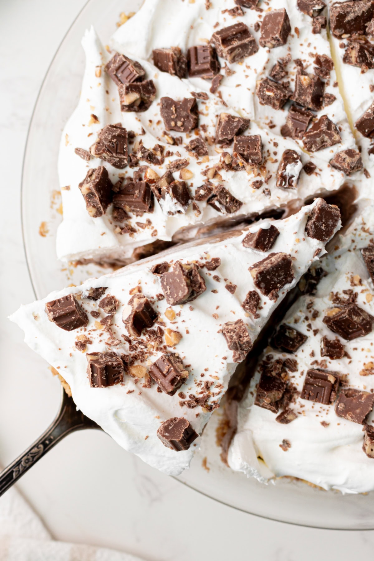 candy bar pie with slice coming out of it