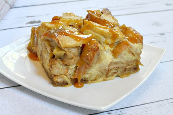 Caramel Apple Bagel Bread Pudding slice on a white plate