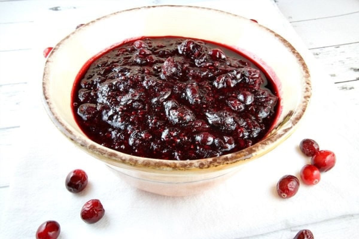 Sweet, tart, and full of flavor — this Sherry Triple Berry Cranberry Sauce combines cranberries, blueberries, and raspberries with a splash of sherry for the ultimate holiday side. sherry triple berry cranberry sauce in a bowl