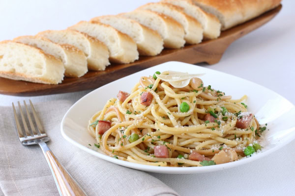 Ham and Bean Skillet Spaghetti recipe from RecipeGirl.com Ham and Bean Skillet Spaghetti serving on plate with bread in background