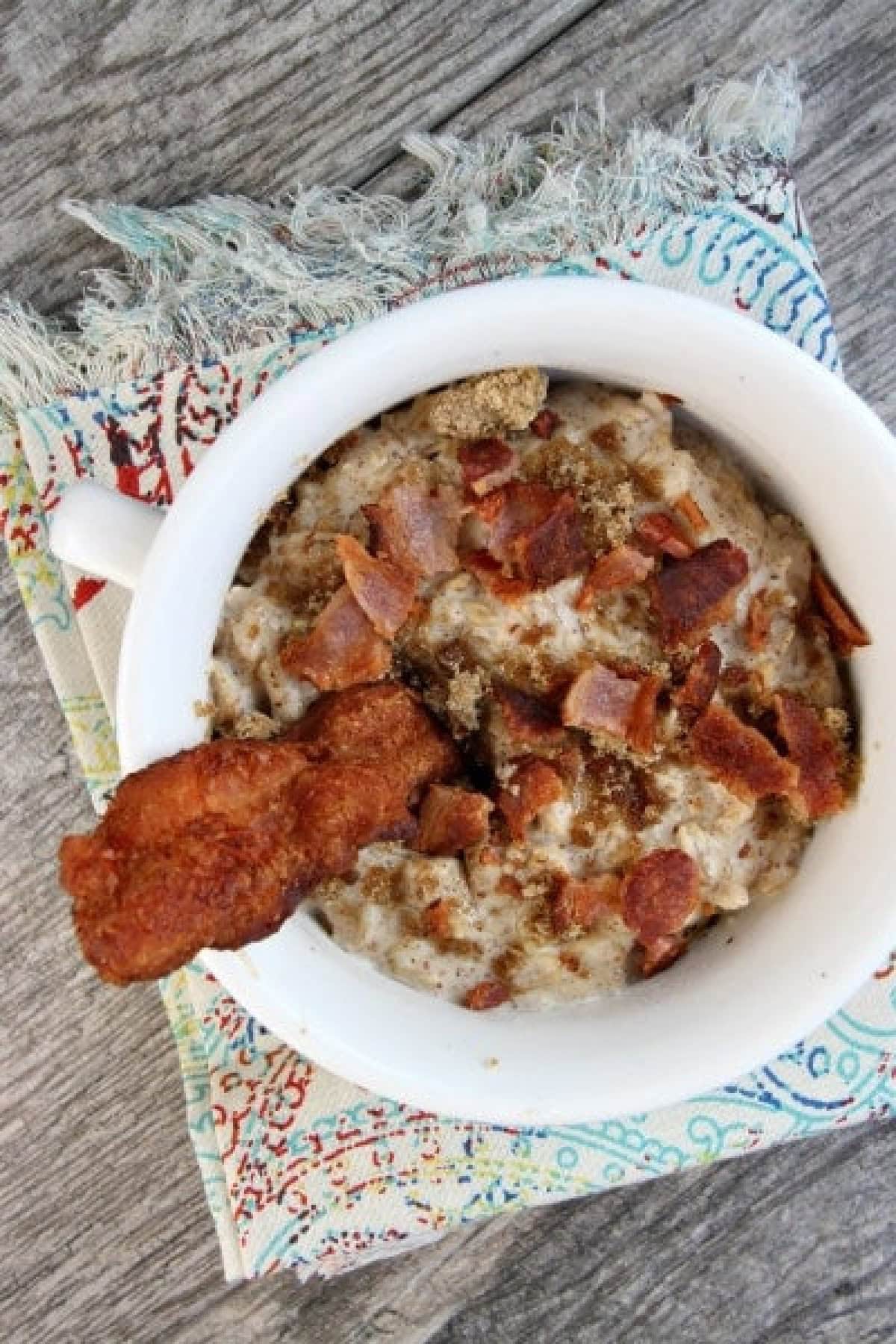 almond butter oatmeal with bacon and brown sugar in white bowl