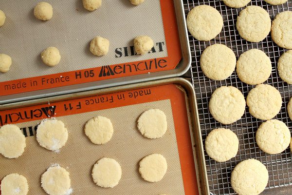 Sugar cookies on baking sheet and cooling rack