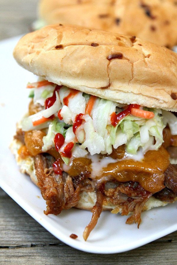 Slow Cooker Sweet and Spicy Pulled Pork Sandwiches on a white platter