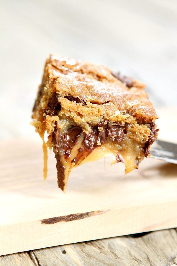 Gooey Salted Caramel Chocolate Chip Cookie Bar lifted up on spatula