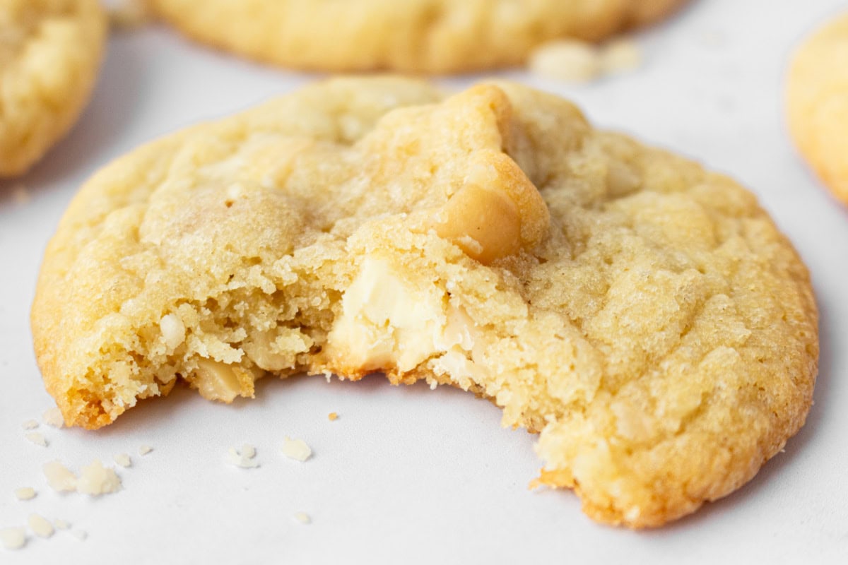 White Chocolate Macadamia Nut Cookies recipe from RecipeGirl.com : perfect classic cookie recipe made famous by Mrs. Fields! close up white chocolate macadamia nut cookie with bite taken out of it