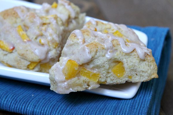 Fresh Peach Scones on a white platter set on a blue napkin