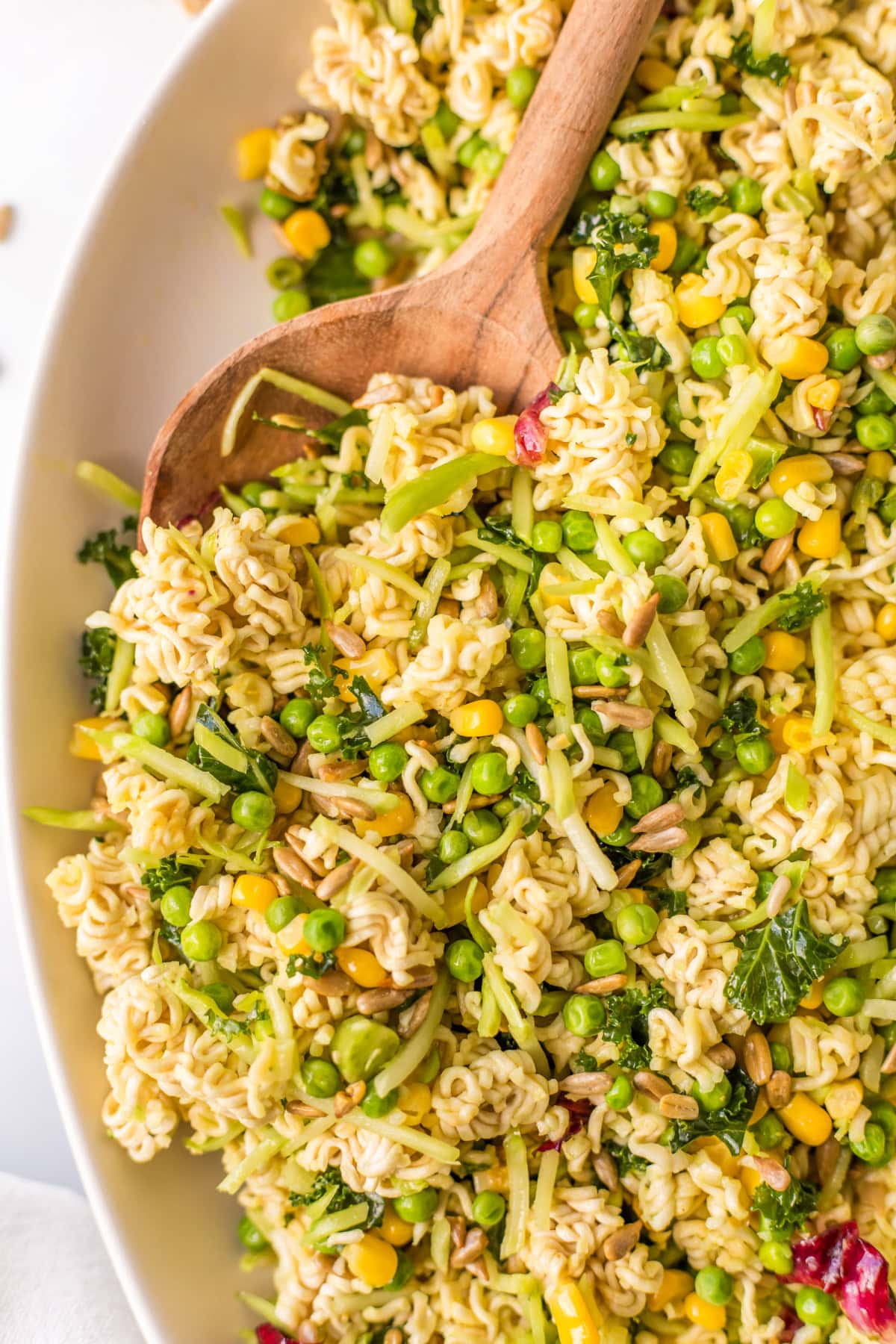 wooden spoon in bowl of ramen salad