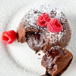 molten chocolate cake broken open to see the gooey inside