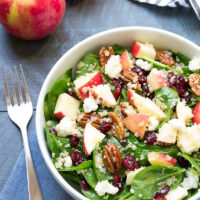 spinach and quinoa salad in a white bowl