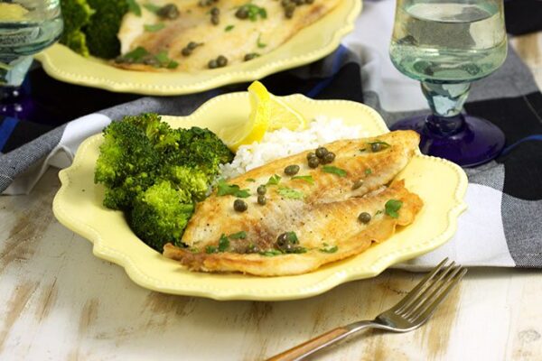 Ready in 10 minutes, this Easy Tilapia Piccata from RecipeGirl.com is a family weeknight favorite dinner recipe.