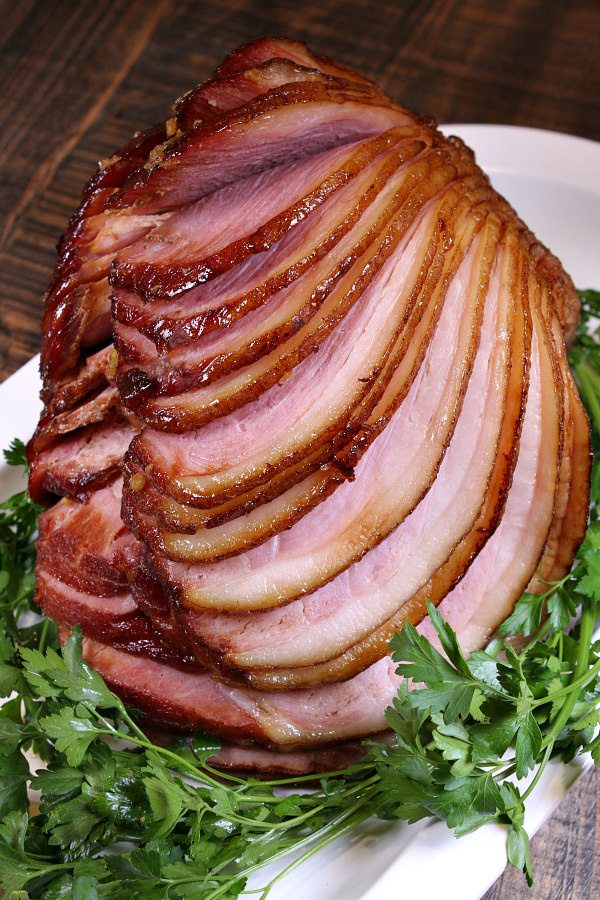 Brown Sugar Glazed Ham  set on fresh parsley on platter