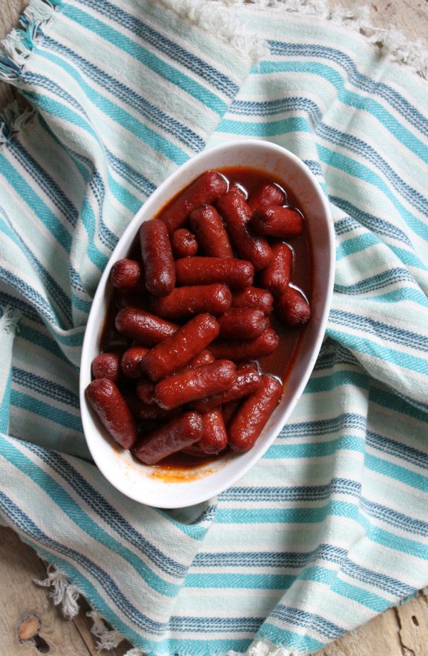 Easy Lil Smokies Appetizer in a white bowl set on a blue striped napkin