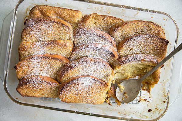 Eggnog French Toast Casserole just out of the oven with a spoon