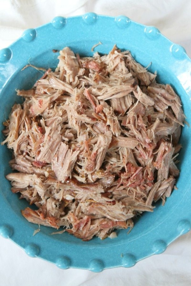 slow cooker kalua pig shredded in blue bowl