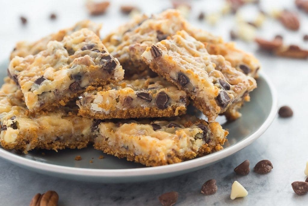 These Seven Layer Bars have a graham cracker crust and are piled with nuts, coconut, chocolate chips and white chocolate chips. Recipe from RecipeGirl.com.