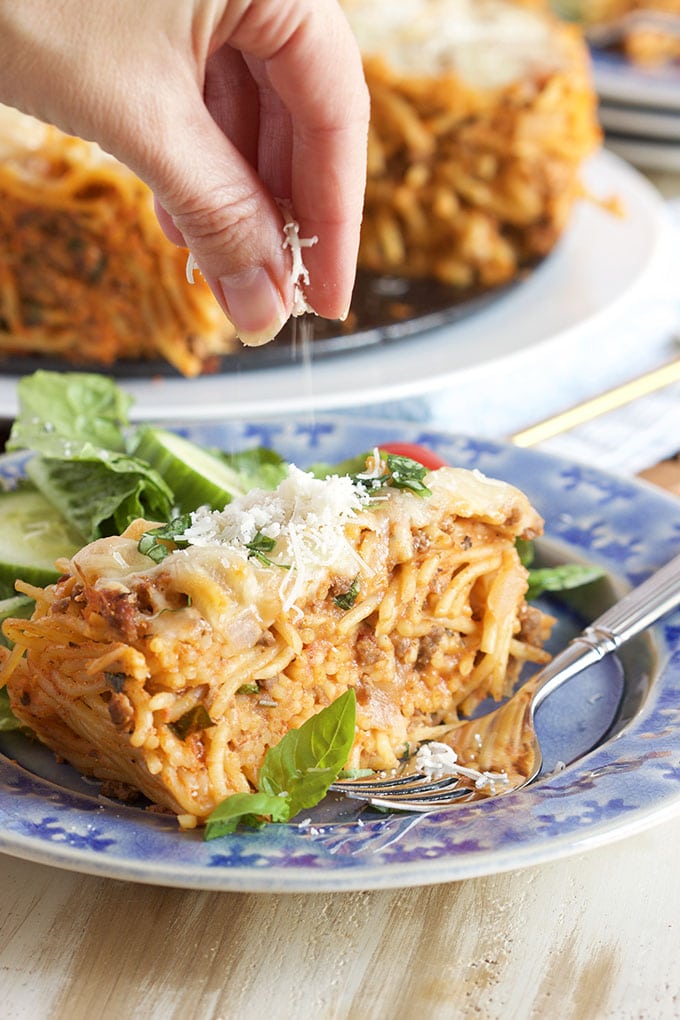 Slice of Easy Spaghetti Pie sprinkled with cheese