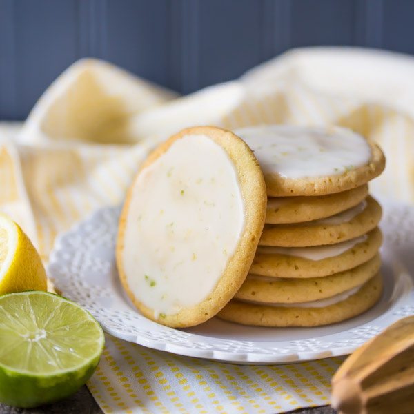 Iced Lemon Lime Cookies stacked on plate