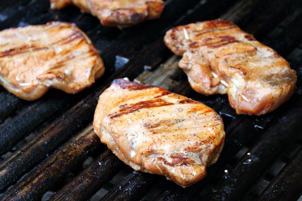 Blue Cheese and Apple Stuffed Grilled Pork Chops grilling on the grill