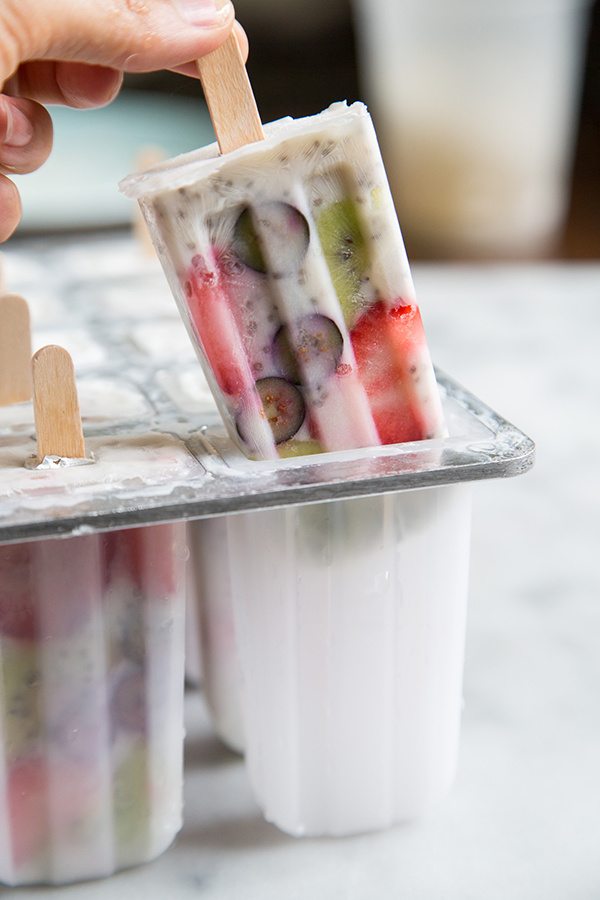 hand pulling out a breakfast popsicle from the popsicle molds