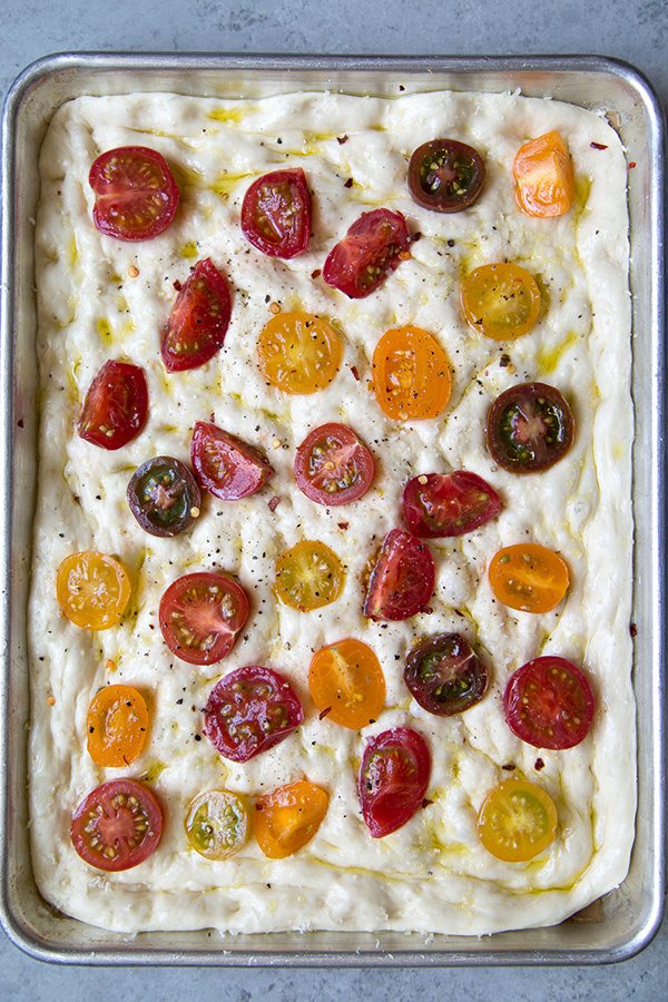 Tomato Focaccia Bread in a sheet pan ready to bake