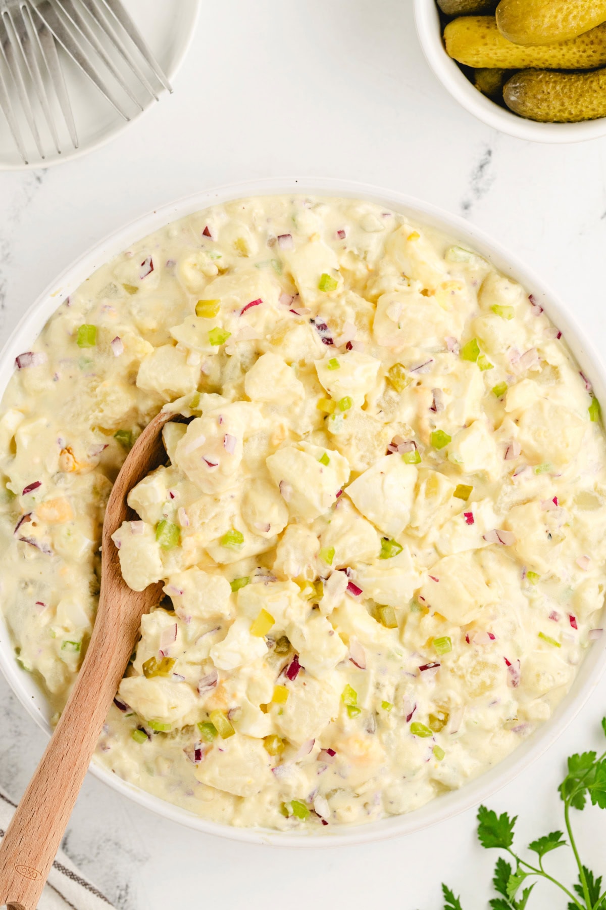 The perfect potato salad for every barbecue! American Potato Salad recipe from RecipeGirl.com bowl of american potato salad with spoon