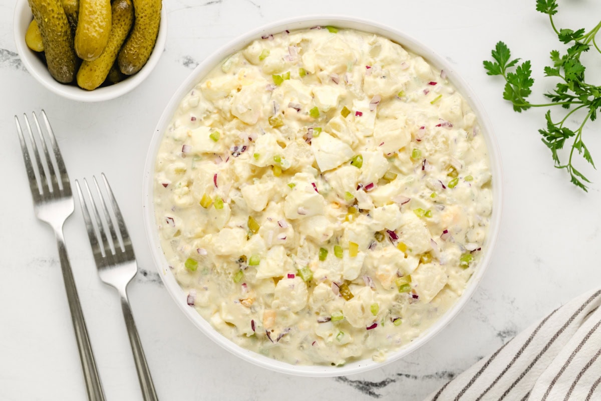 The perfect potato salad for every barbecue! American Potato Salad recipe from RecipeGirl.com bowl of american potato salad