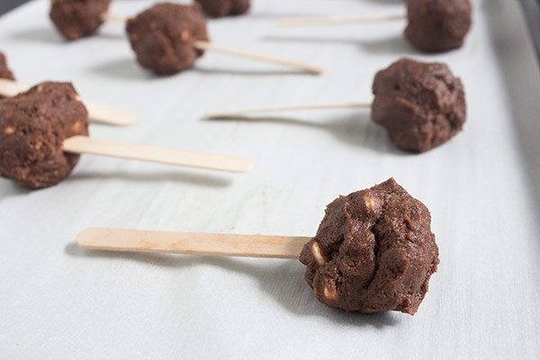 chocolate cookie dough on popsicle sticks for making cookie pops