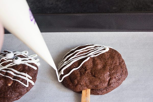adding white chocolate to chocolate cookie pops