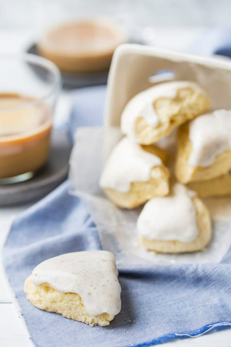 vanilla bean scones spilling out of a display basket with coffee in the background- on top of a blue napkin
