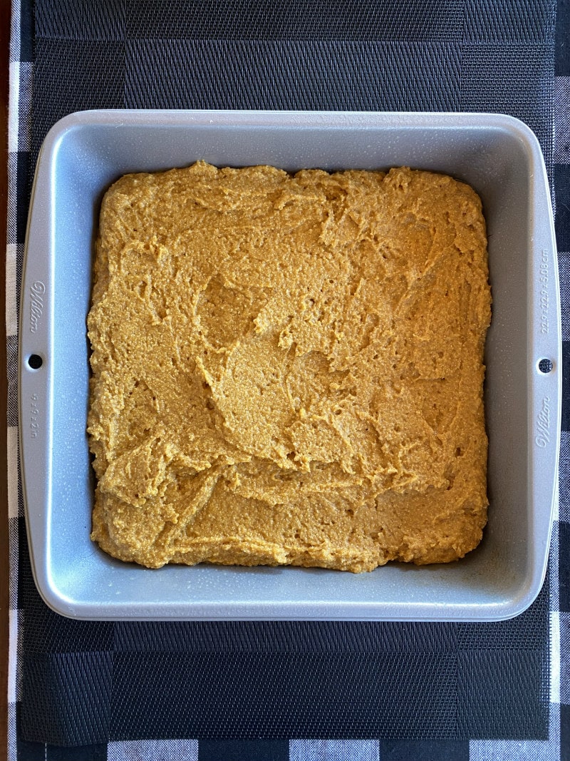 pumpkin cornbread in a baking pan ready for oven