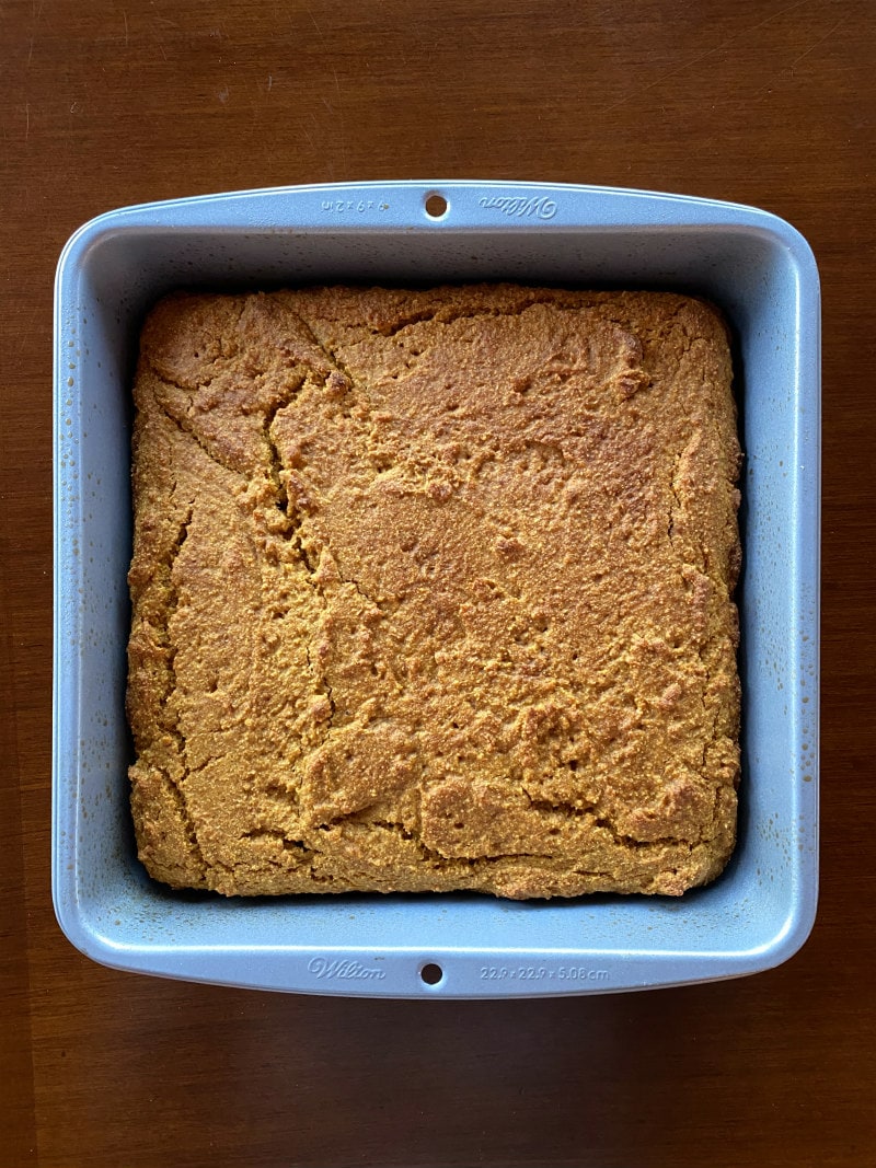 pumpkin cornbread in a baking pan just out of the oven