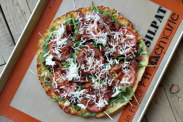 preparing Cauliflower Crust Bacon and Egg Pizza 