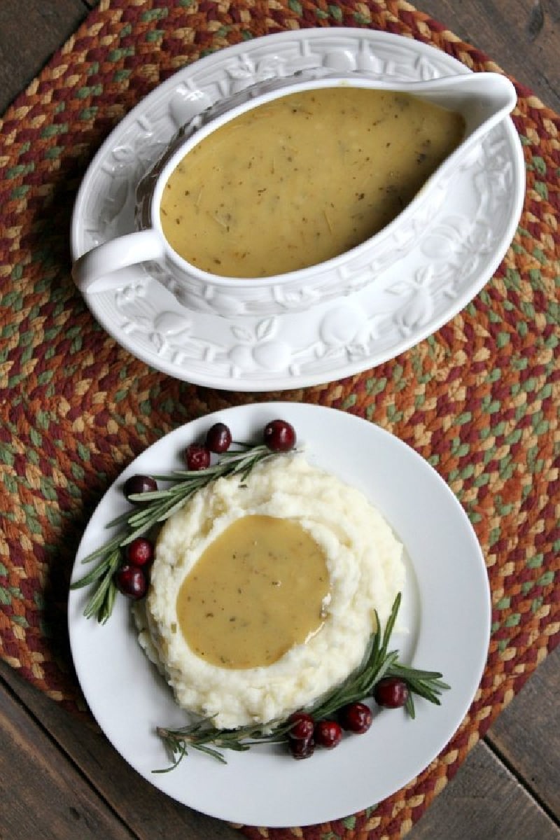 gravy boat and mashed potatoes with gravy on plate